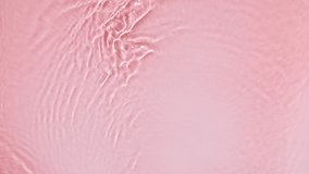 Pure pink water with reflections sunlight in slow motion. Water surface texture. Sun and shadows. Motion clean swimming pool ripples and wave. - Powered by Shutterstock - Get 15% off with code: PIKWIZARD15