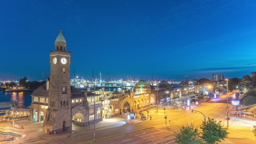 Hamburg Germany time lapse 4K, city skyline night timelapse at St. Pauli Landing Bridges (Landungsbrücken) pier and Hamburg harbour