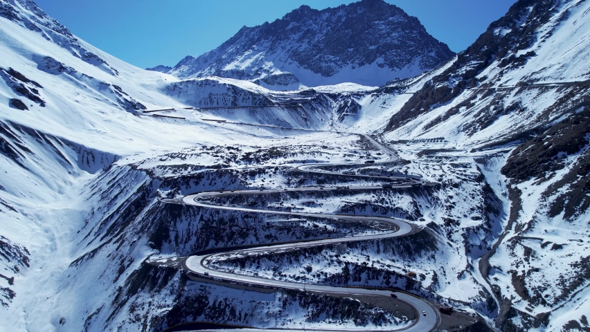 Curves background. Curves road. Famous Los Caracoles highway road near border between Chile and Argentina. Scenery curves at snowning scenery. Transportation scenery. Famous Los Caracoles road.