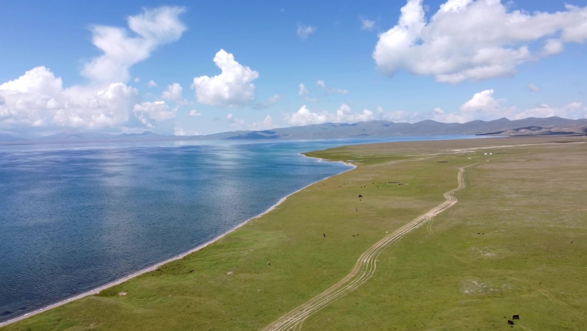 Mans ride on horses near to Song-Kul lake in Kyrgyzstan. Drone footage 4K. | Shutterstock HD Video #1093289241