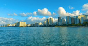 Gorgeous Honolulu city from the ocean. Tall buildings on Waikiki Beach in Oahu. Skyscrapers in Hawaii.  Shoreline of Hawaiian island. Hotel and houses along the tropical island. Island during sunset