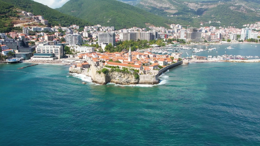 Aerial view of Budva, old and modern city on Adriatic Sea coast. Center of Montenegrin tourism and popular sea resort. | Shutterstock HD Video #1093292617