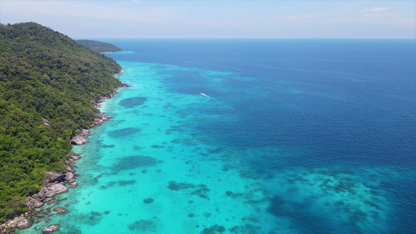 Similan Islands in Asia, Thailand has beautiful white sand beaches, amazing landscapes blue water, like paradise, suitable for travel vacation in summer quiet diving snorkeling panoramic aerial footag Royalty-Free Stock Footage #1093300865