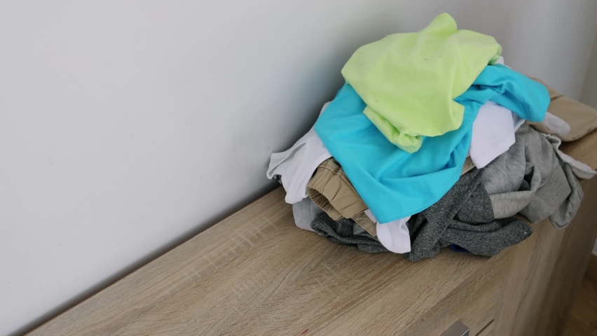 close-up of a woman who collects dirty laundry for washing Royalty-Free Stock Footage #1093301541