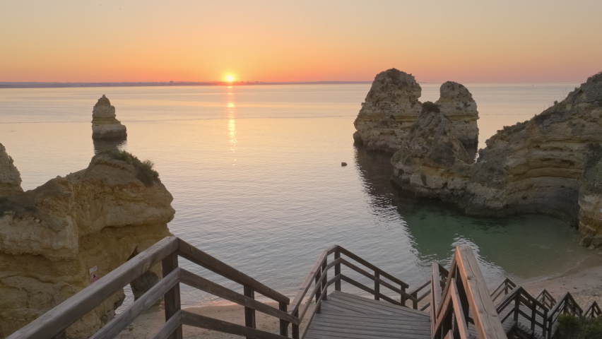 Praia do Camilo beach at sunrise near Lagos town, Algarve province, Portugal. Slow revealing footage of the beautiful Camilo beach in the morning. White sand beach with in rocky lagoon.  | Shutterstock HD Video #1093306441