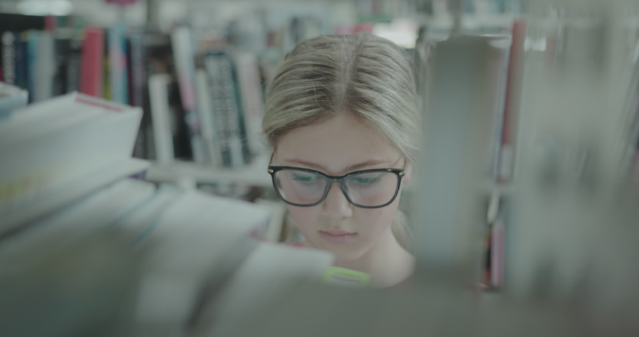 Female High school Education Student Browsing Books in University Library Royalty-Free Stock Footage #1093308327