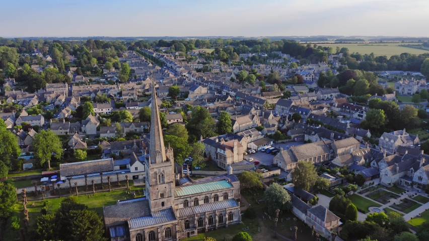 Aerial Drone View of Cotswolds Village and Burford Church in England, a Popular English Picturesque Tourist Destination in the Countryside of Gloucestershire Royalty-Free Stock Footage #1093315969