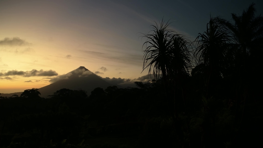 Arenal Volcano Landscape of Costa Rica Tropical Rainforest and Jungle Scenery at Sunset with Dramatic Orange Sky in Central America Royalty-Free Stock Footage #1093316001