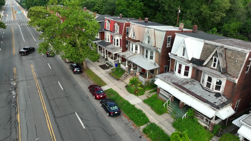 Homes in USA. Rental properties along urban street in America. Aerial establishing shot. Royalty-Free Stock Footage #1093317323