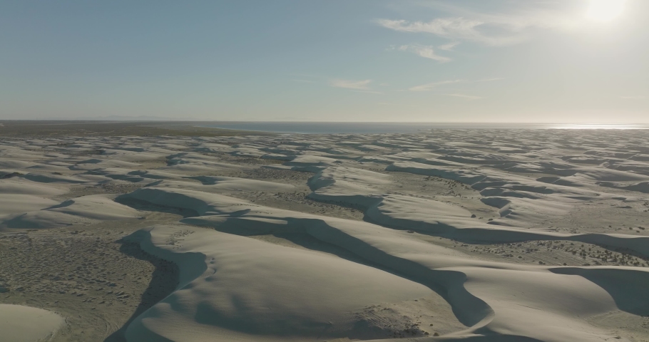 Beautiful Sand Dune Scenery of Baja California Sur Shoreline, Aerial Flight with Copy Space in Sky
