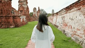 young beautiful woman traveling and taking photo at Thai historical Park, Holidays and cultural tourism concept.