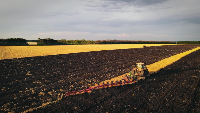 An aerial view of tractor plows the agricultural field Nature Videos ...