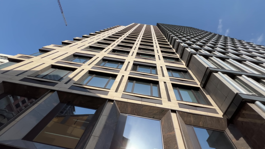 Luxury residential skyscraper exterior in downtown on a sunny summer day. Bottom up view. Wide angle shot Royalty-Free Stock Footage #1093327509