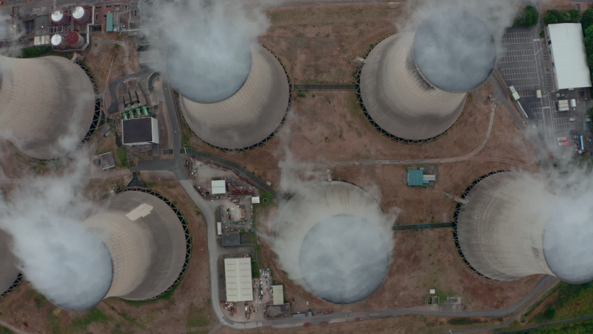 Top down slider drone shot of Large power plant cooling towers from above