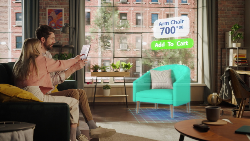 Decorating Apartment: Couple Holding Digital Tablet Computer, using Augmented Reality Interior Design Software Chooses 3D Furniture for Home. Pick a Stylish Chair for the Living Room. Side View - Powered by Shutterstock - Get 15% off with code: PIKWIZARD15