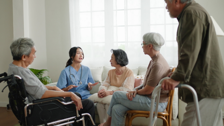 Group of asian senior people listening to young nurse.Psychological support group for elderly therapy session in a community centre. Group therapy in session sitting in a circle in a nursing home. Royalty-Free Stock Footage #1093345777