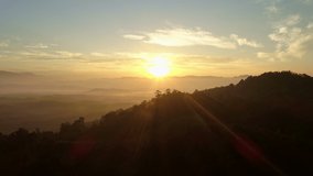 Aerial view Drone flying through the fog above mountain peak Beautiful light sunrise or sunset nature Landscape Amazing video cinematic nature view in Thailand