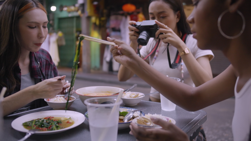 A group of multi-ethnic female friends enjoying street food on Yaowarat Road or Chinatown in Bangkok, Thailand. Royalty-Free Stock Footage #1093363357
