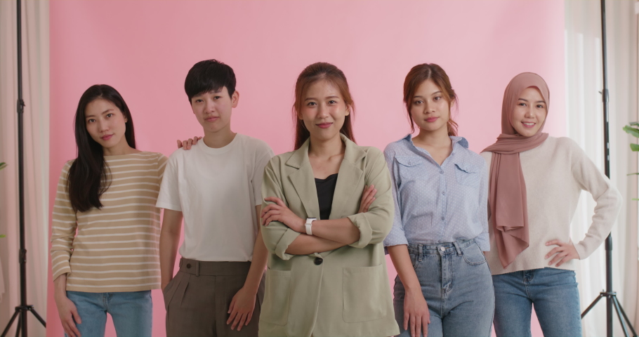 Diverse group of young asia Gen z girl arm cross happy face look at camera in model shooting studio shot. Power of people woman's day right or gay youth LGBT pride unity team strong cool proud smile. | Shutterstock HD Video #1093366475
