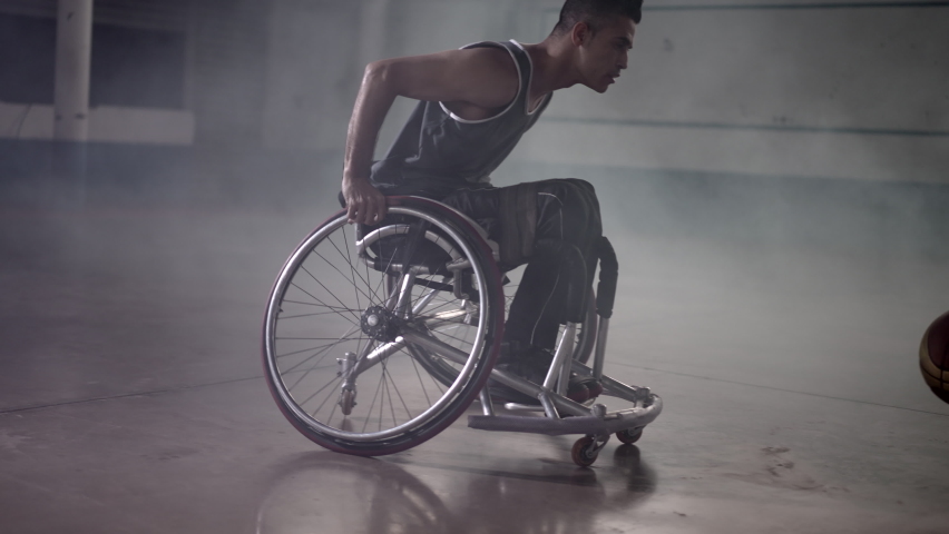 Athlete in wheelchair with grabbing ball and passing to team member. person training sport Royalty-Free Stock Footage #1093369393