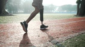 An athleti man with prosthetic leg running on racing runner track in the morning - Powered by Shutterstock - Get 15% off with code: PIKWIZARD15