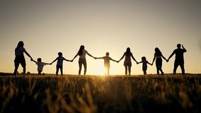 Happy family. Silhouette of large group of people at picnic in park. The family generation walks on the green grass. Parents and children play in nature. Family walking together across field at - Powered by Shutterstock - Get 15% off with code: PIKWIZARD15