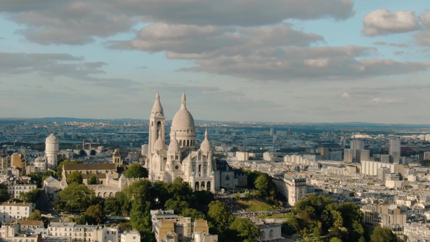 Establishing aerial view of Paris Sacre-Coeur Basilica Church and butte Montmartre hill on a beautiful day, Paris France attractions