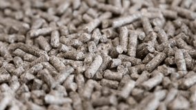 pellets of compound feed for feeding fish, animals and birds of poultry farms. Feed pellets background. dolly video