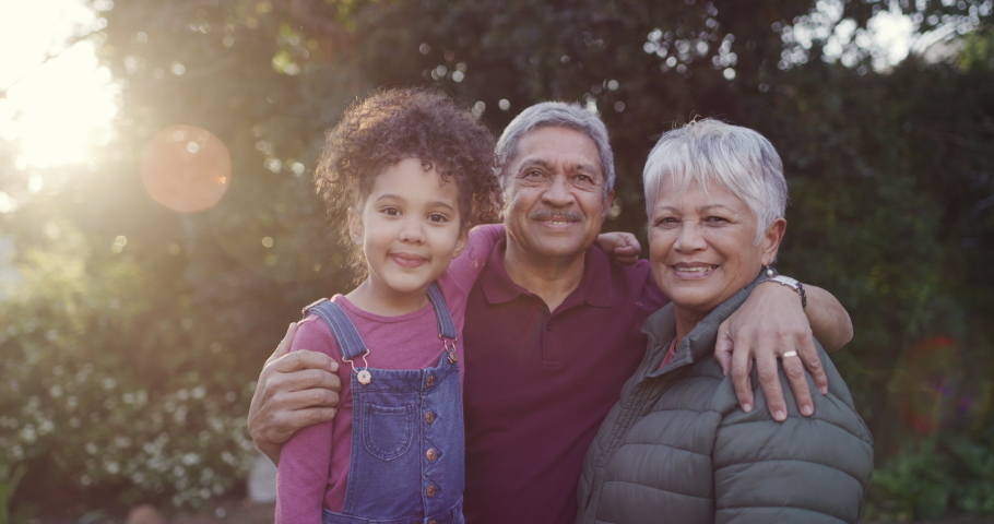 Smiling, happy and loving grandparents bonding with their cute granddaughter in a park, garden or yard on a sunny day outdoors. Portrait of a loving family relaxing, laughing and having fun together | Shutterstock HD Video #1093375141