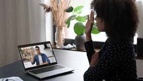 Collaboration concept. Two people of different nationalities are talking on a video conference. African American woman and Indian man, friends or work colleagues, communicate by video call uses