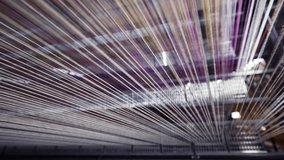 Yarn thread lines on the weaving loom machine in textile factory. Textile machine with red and yellow threads. Carpet factory, carpet production. Close up, 4K .  - Powered by Shutterstock - Get 15% off with code: PIKWIZARD15