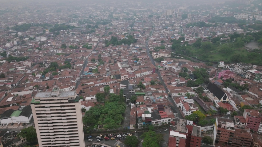 Slow aerial flyover on a foggy morning in Cali, Colombia.