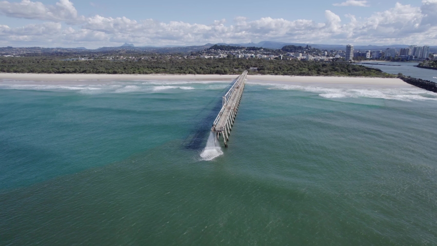Sand-Water Mixture Discharging Through Tweed Sand Bypassing Facility On A Jetty At The Letitia Beach In Fingal Head, NSW, Australia. aerial drone Royalty-Free Stock Footage #1093380259