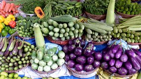 The seller displayed colorful summer vegetables in a stall. Many varieties of colorful vegetables are in the Dhaka city market. Colorful vegetable background. 4k video.