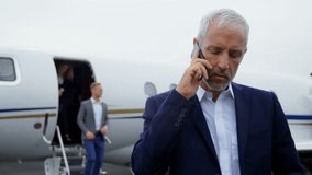 Animation of heart icons over caucasian businessman using smartphone. Global business and digital interface concept digitally generated video. - Powered by Shutterstock - Get 15% off with code: PIKWIZARD15