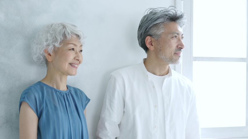 gray hair asian couple putting on eye glasses  