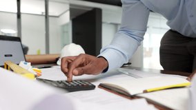 Construction manager working on budget, planning business strategy and making finance calculations at work. Closeup of hands of engineer or architect calculating and doing paperwork - Powered by Shutterstock - Get 15% off with code: PIKWIZARD15