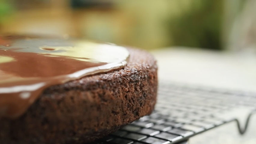 Spreading chocolate icing over the cake. Royalty-Free Stock Footage #1093397829