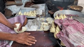 Video of cook preparing samosa or singara is a fried or baked pastry filled with savory ingredients such spicy potatoes, onions, and peas that is frequently served with chutney.