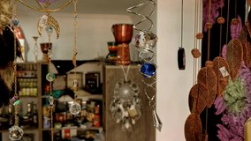  The sound of the wind. Wind chimes hanging in a souvenir shop .Home and garden decoration. Relaxing music concept. Garden decoration, wind chimes to hang under the roof of the balcony of a house. 