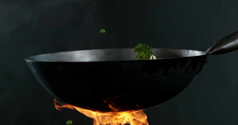 Super slow motion of flying asian noodles with vegetable from pan. Filmed on high speed cinema camera, 1000 fps.