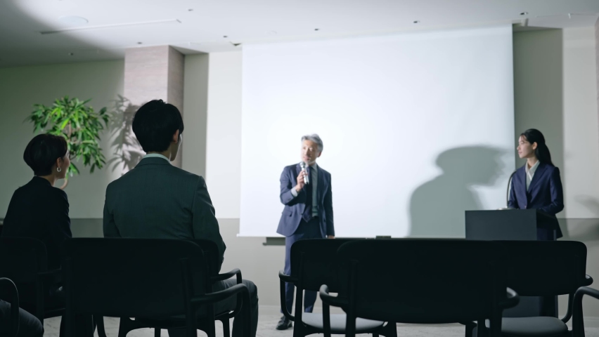 Asian middle aged man giving a lecture and audience. Royalty-Free Stock Footage #1093403907
