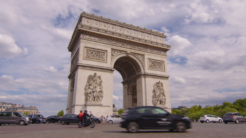 Timelapse of traffic at Arc de Triomphe in a summer day. This historical monument overlooks the avenue des champs elysees in the heart of Paris, French capital Royalty-Free Stock Footage #1093404673