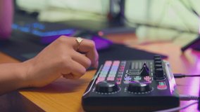 Close up of female vlogger using editing console for live stream - shot in slow motion