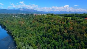 Trezzo sul Adda, Italy. Aerial view of a mountain freshwater river with a low water level surrounded by green trees. White swans on the river. Forest. Wildlife. Green Planet. Ecology. drone video