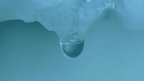 Ungraded: Melting ice. Drops of water dripping from a melting frozen piece of ice and snow due to warming or defrosting. Ungraded H.264 from camera without re-encoding. - Powered by Shutterstock - Get 15% off with code: PIKWIZARD15