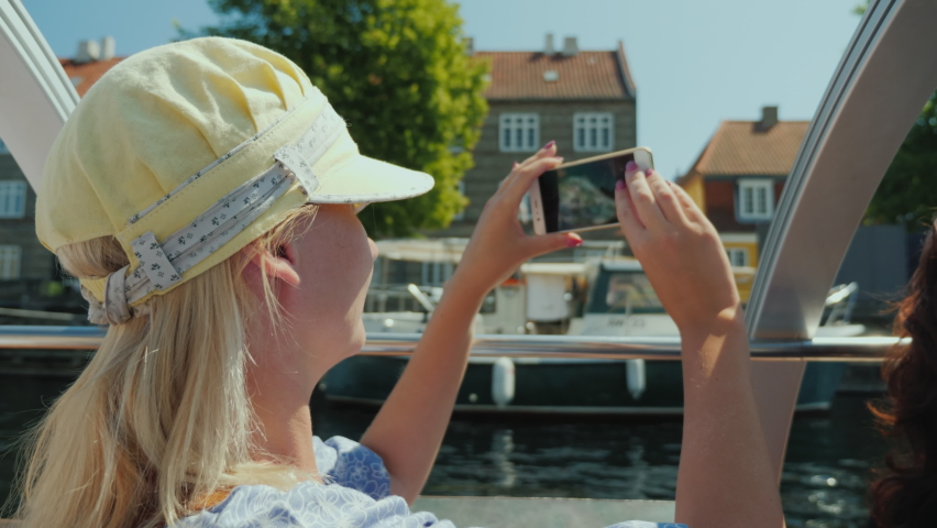 A woman takes pictures of Copenhagen