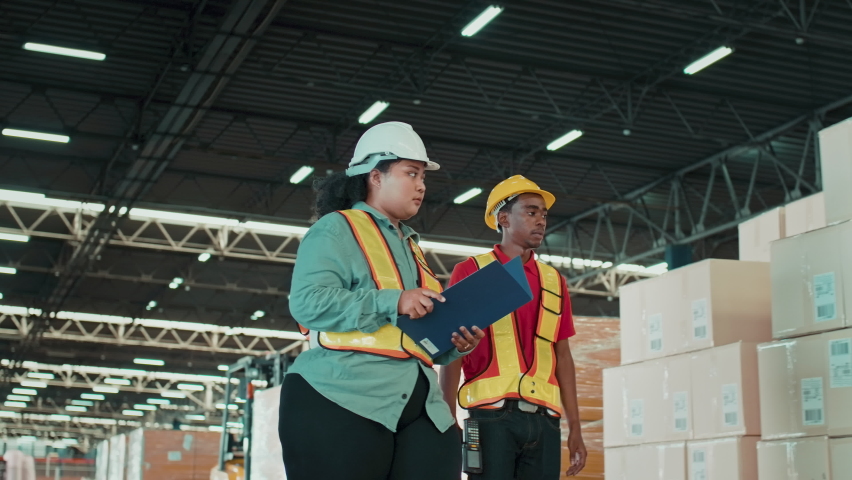 Young woman boss is complaining with her worker while checking inventory and counting product on shelf in modern warehouse. Royalty-Free Stock Footage #1093416201