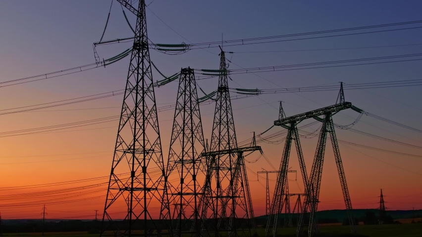  The silhouette of high-voltage poles against the background of the sunset sky. Tower of power lines. Distribution of high-voltage current along the power transmission line. Electricity poles Royalty-Free Stock Footage #1093424141