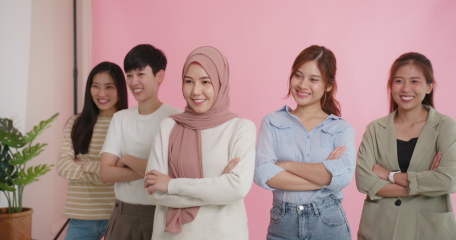 Diverse group of young asia Gen z girl arm cross happy face look at camera in model shooting studio shot. Power of people woman's day right or gay youth LGBT pride unity team strong cool proud smile. | Shutterstock HD Video #1093433651